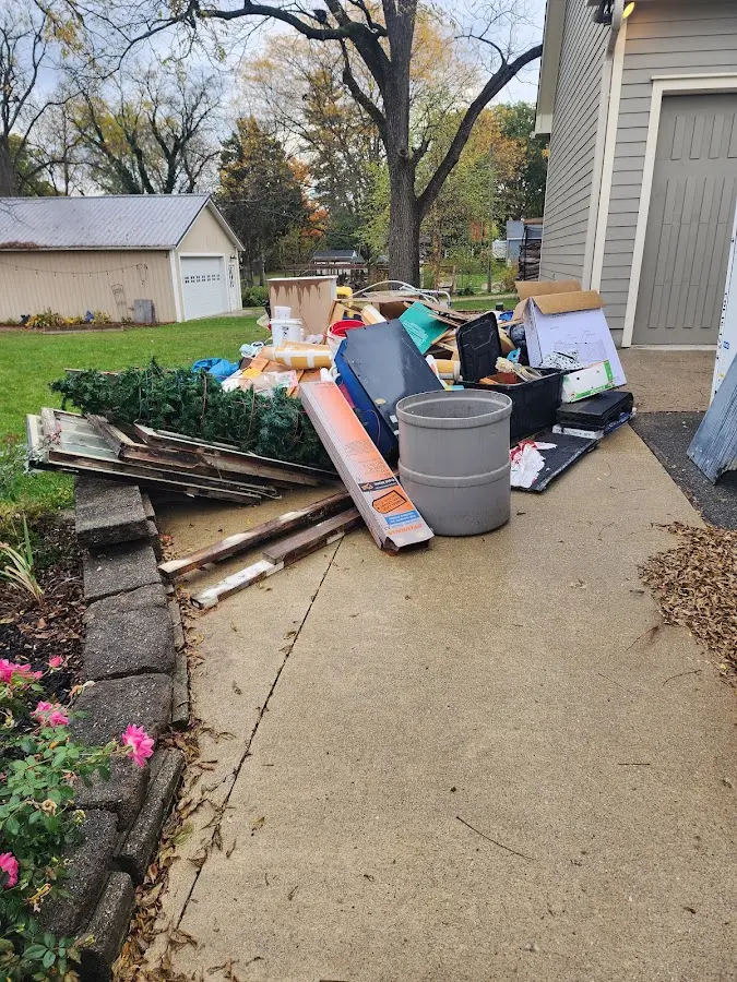 Dumpster being loaded with debris for Estate Cleanout Dumpster Rental in Longmeadow